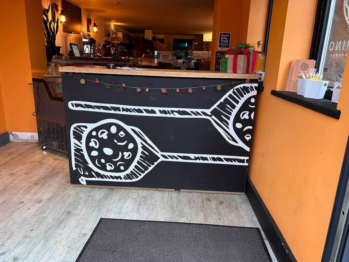 Black counter with white design in a pizza restaurant setting
