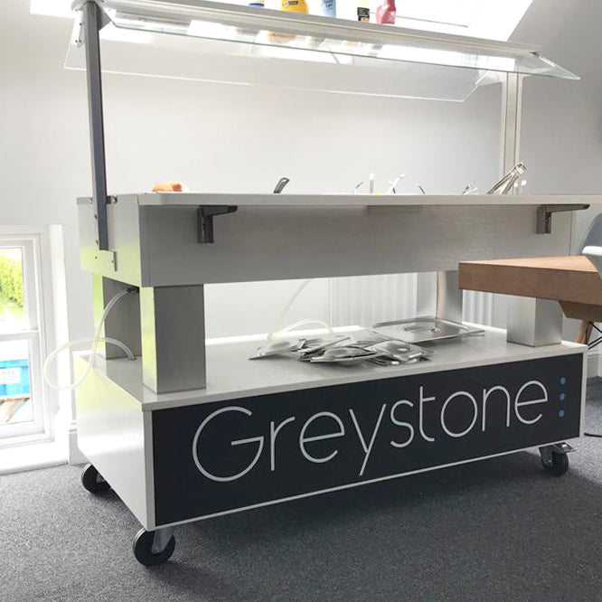 Food cart with 'Greystone' branding in an indoor setting