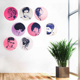 Wall with circular decals of hairstyles and a potted plant on a wooden floor.