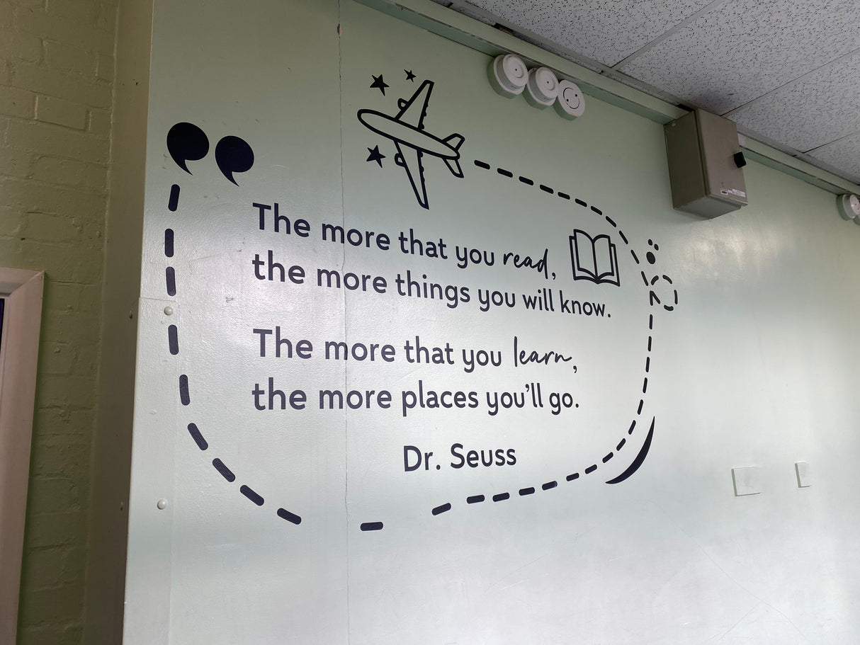 Wall with Dr. Seuss quote and airplane illustration in a classroom setting