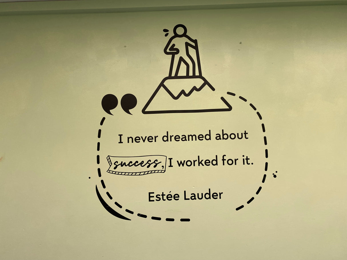 Motivational quote from Estée Lauder with a silhouette of a person on top of a mountain.