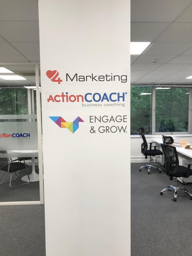 ActionCOACH office with branding on a wall