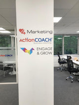 ActionCOACH office with branding on a wall