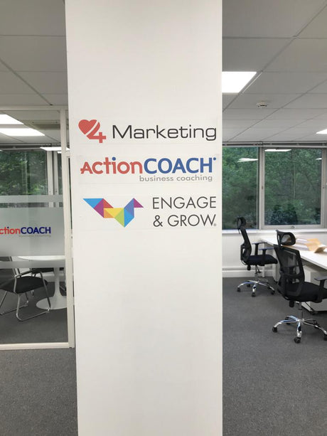 ActionCOACH office with branding on a wall