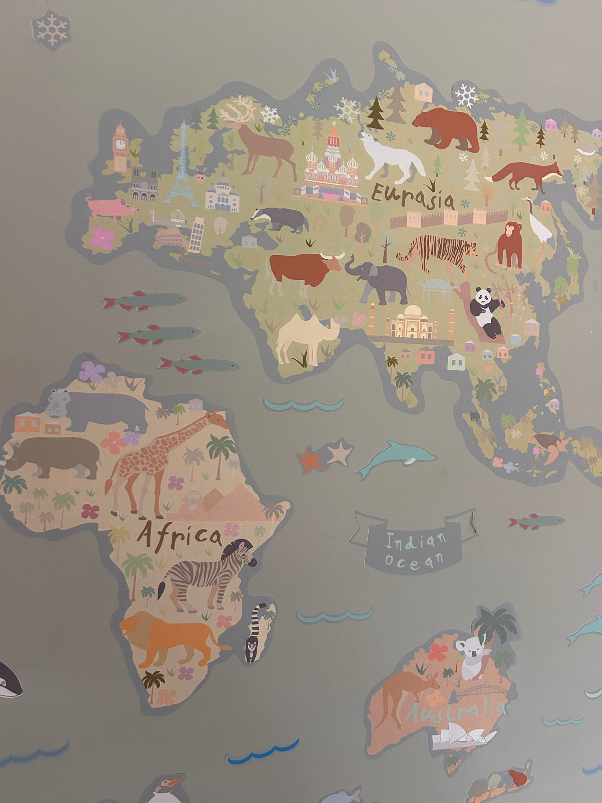 Map of the world with animal illustrations on a gray background