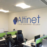 Office space with 'Altinet' branding on the wall, featuring desks and computer equipment.