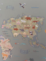Children's map of the world with animal illustrations on a gray background