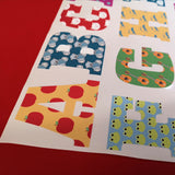 Colorful letter-shaped stickers on a red background