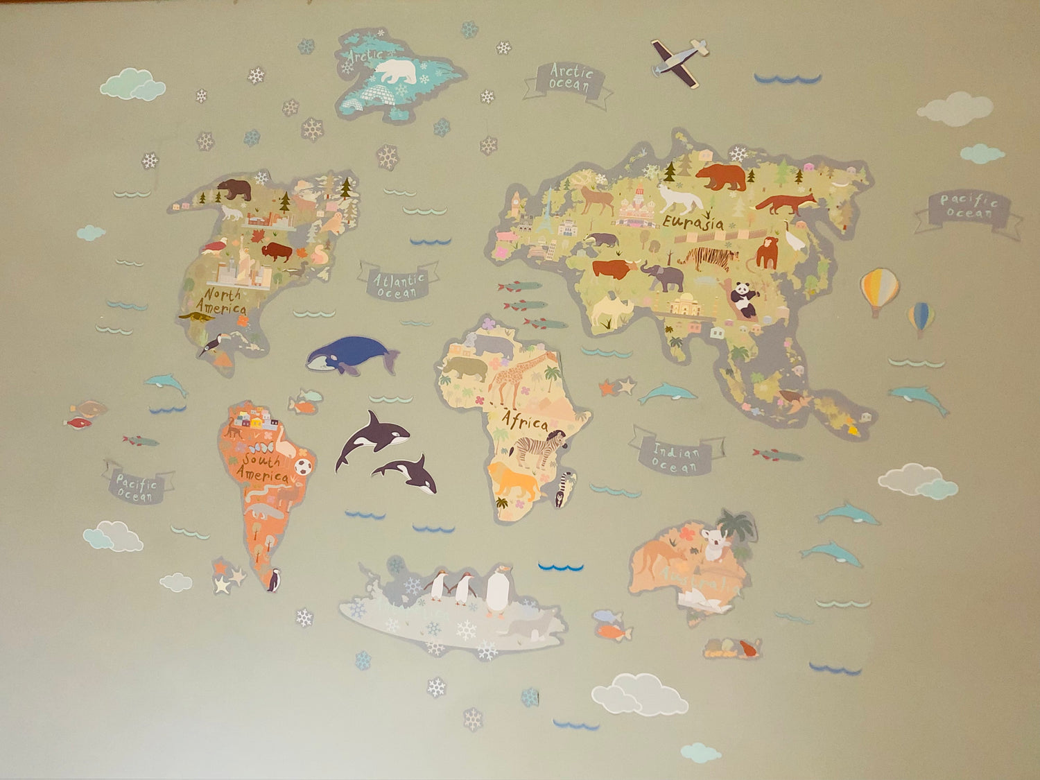 World map with animal illustrations on a beige background