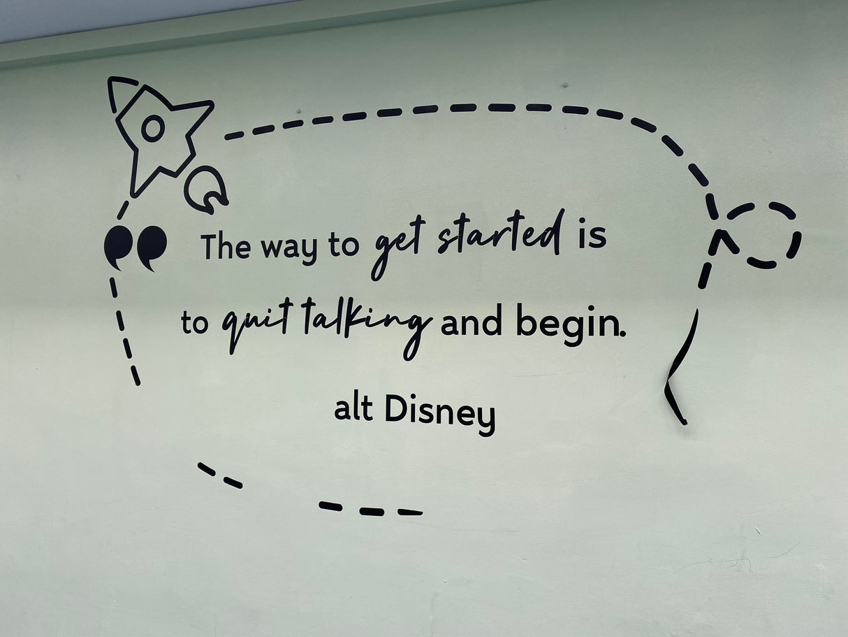 Motivational quote on a whiteboard with a rocket and speech bubble design, featuring 'alt Disney' text.