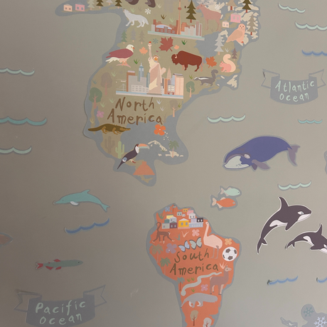 Map of North and South America with animals and landmarks on a gray background